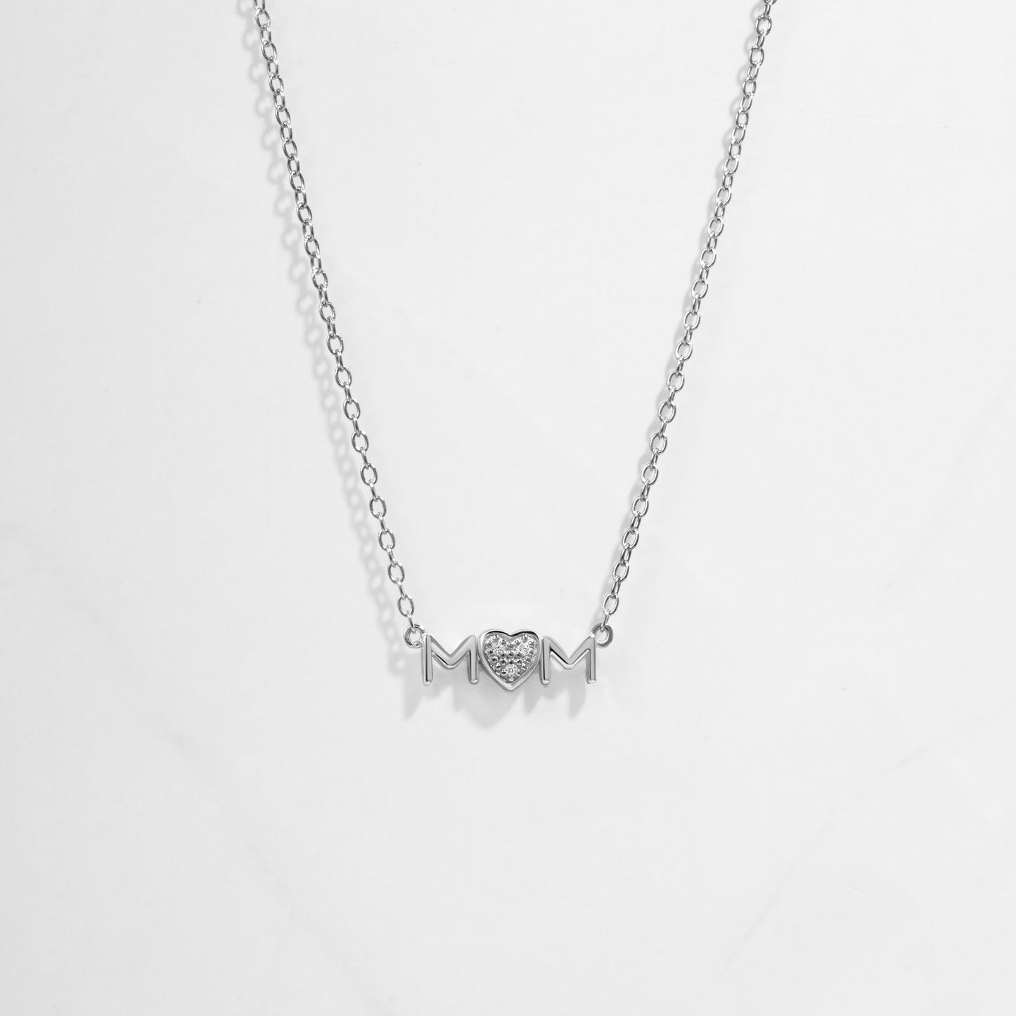 Closeup image of dainty Mom Heart Pendant on silver chain