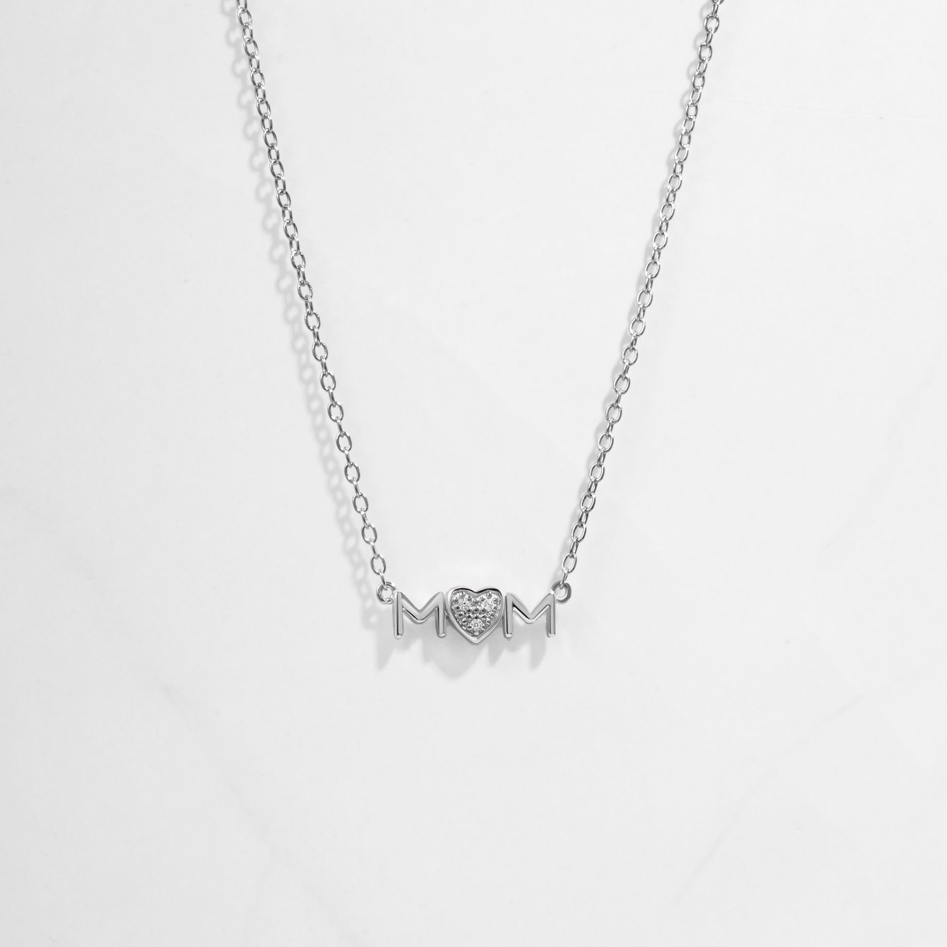 Closeup image of dainty Mom Heart Pendant on silver chain