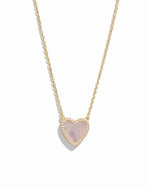 Close-up of a Mother of Pearl Heart Necklace with a smooth, luminous heart pendant on a delicate gold chain.
