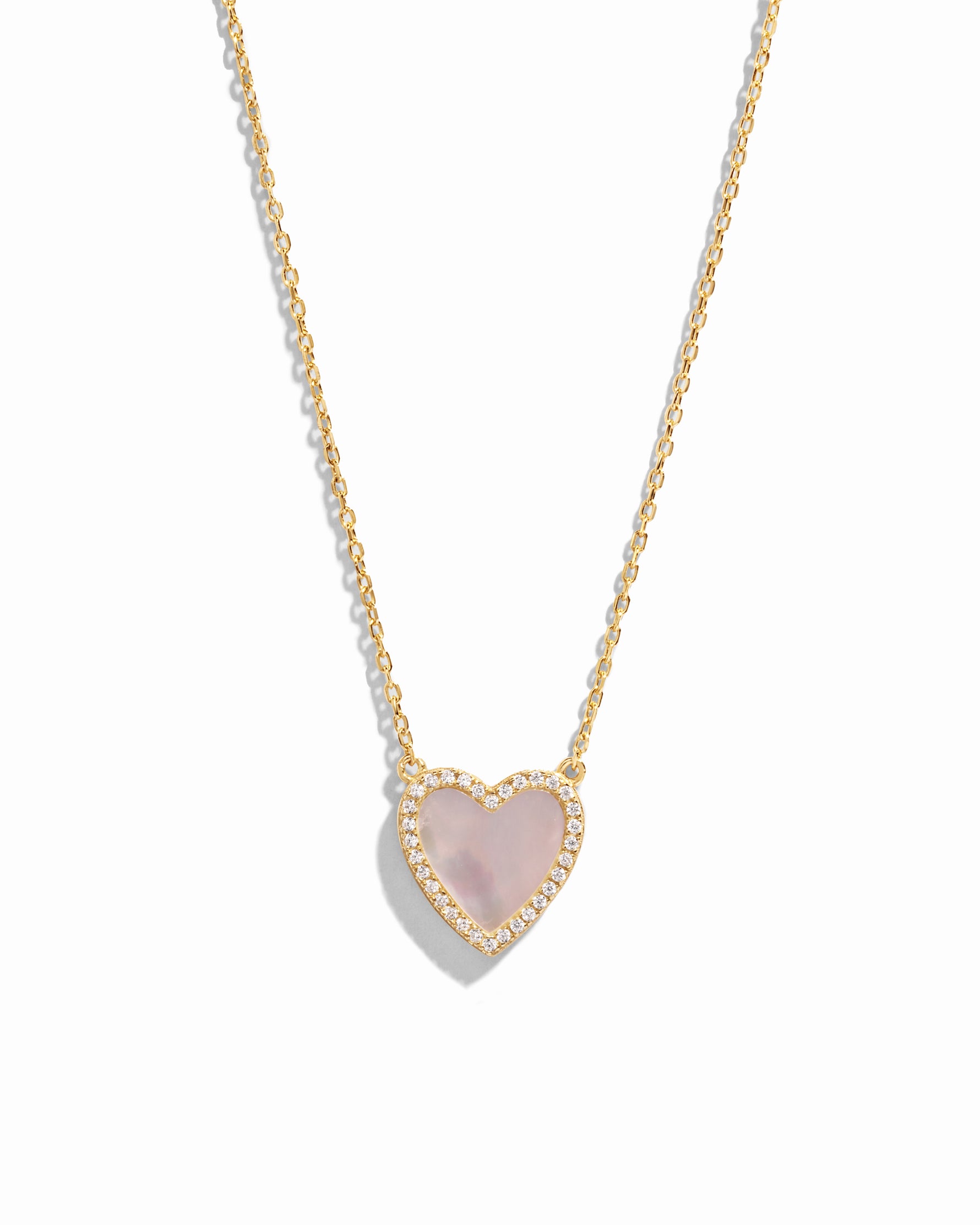 Close-up of a Mother of Pearl Heart Necklace with a smooth, luminous heart pendant on a delicate gold chain.
