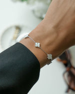 model wearing sterling silver four leaf clover chain bracelet with black long sleeve