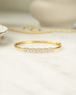 Gold diamond bracelet with a bangle design and cubic zirconia stones