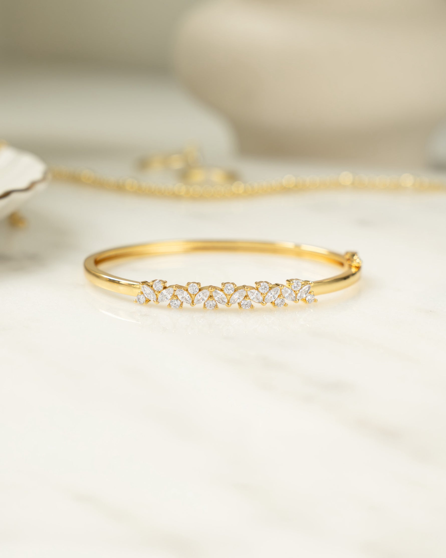 Gold diamond bracelet with a bangle design and cubic zirconia stones