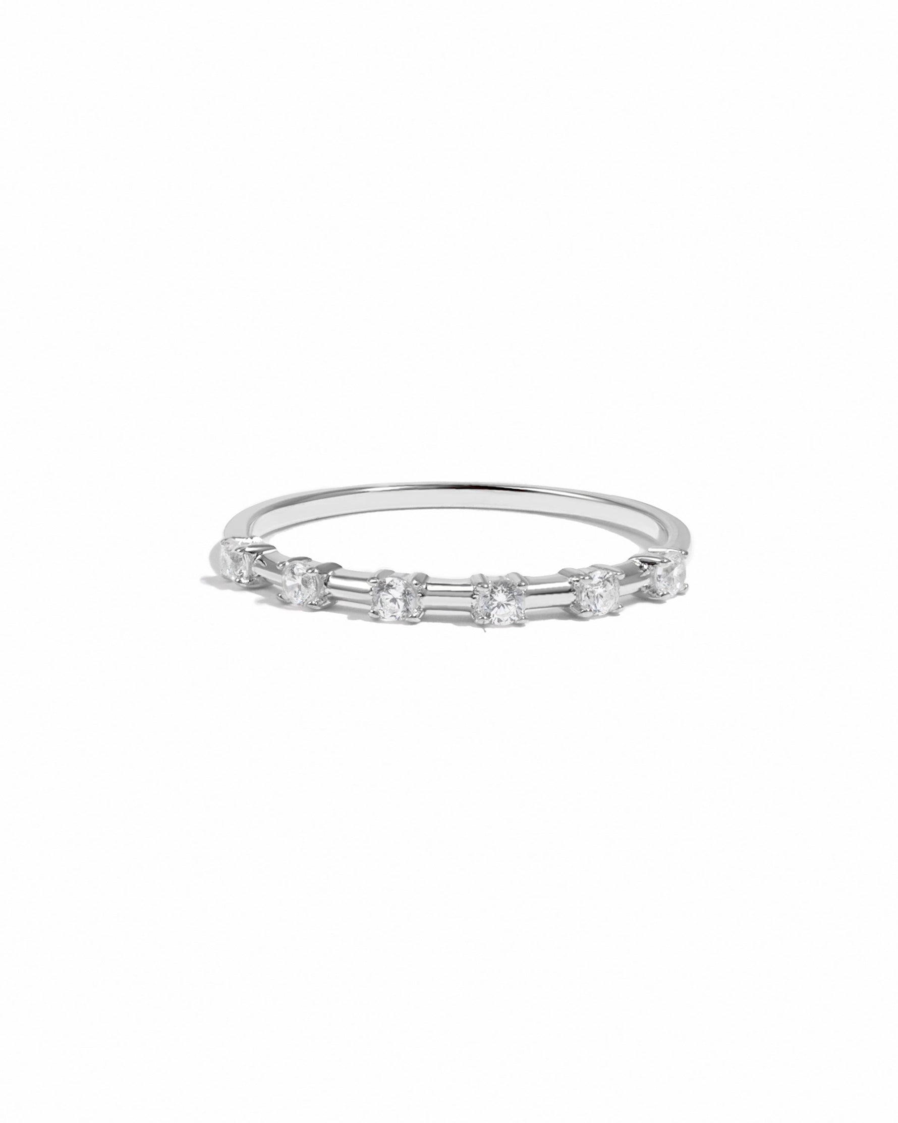 Silver stackable ring with six small stones on a white background