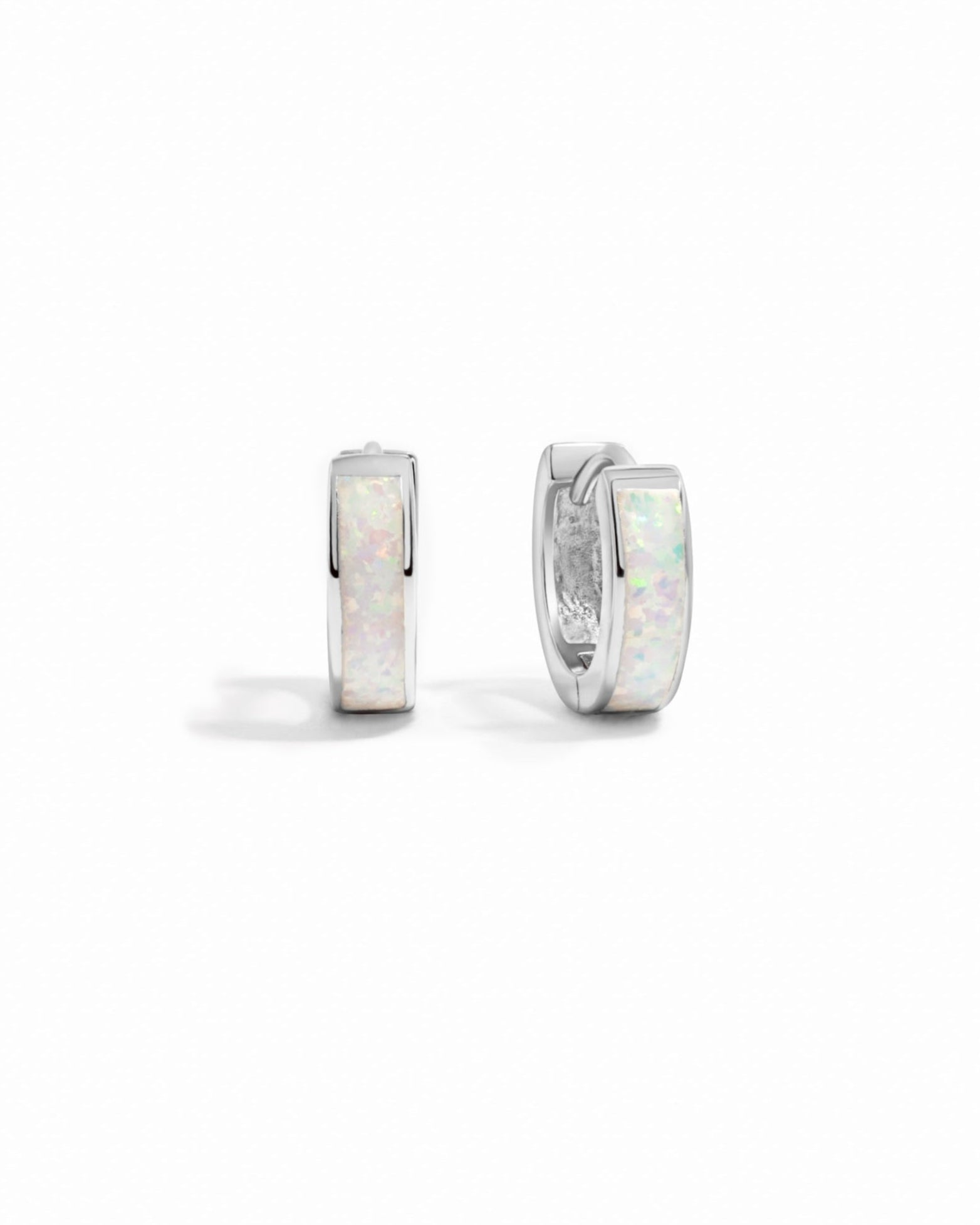closeup image of silver opal huggie earring