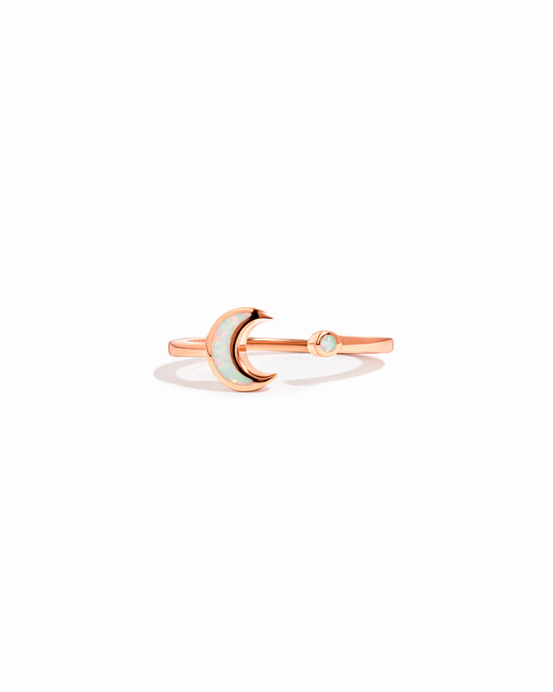 closeup image of rose gold opal moon ring