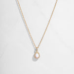 Closeup image of 14k gold plated necklace with opal gemstone