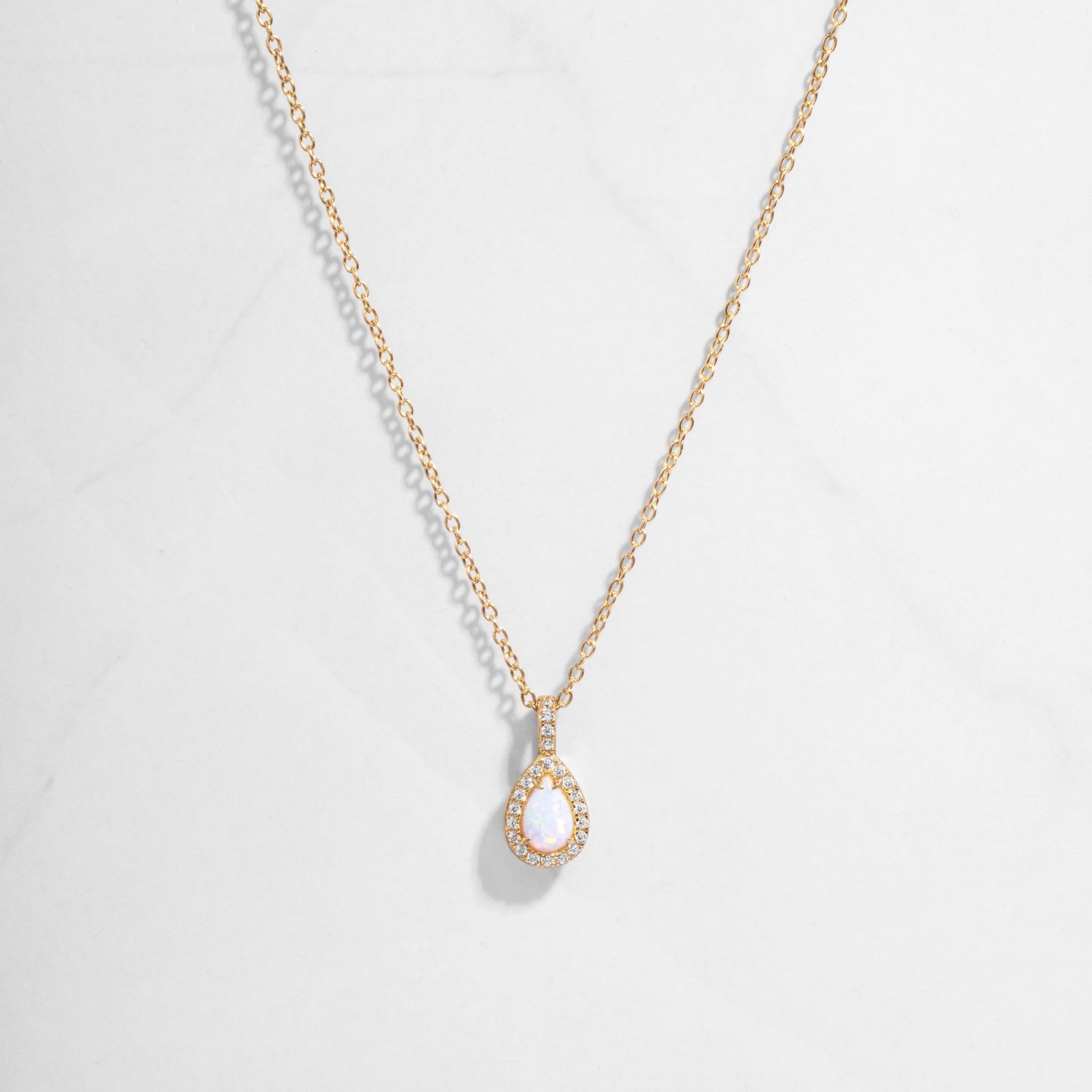 Closeup image of 14k gold plated necklace with opal gemstone