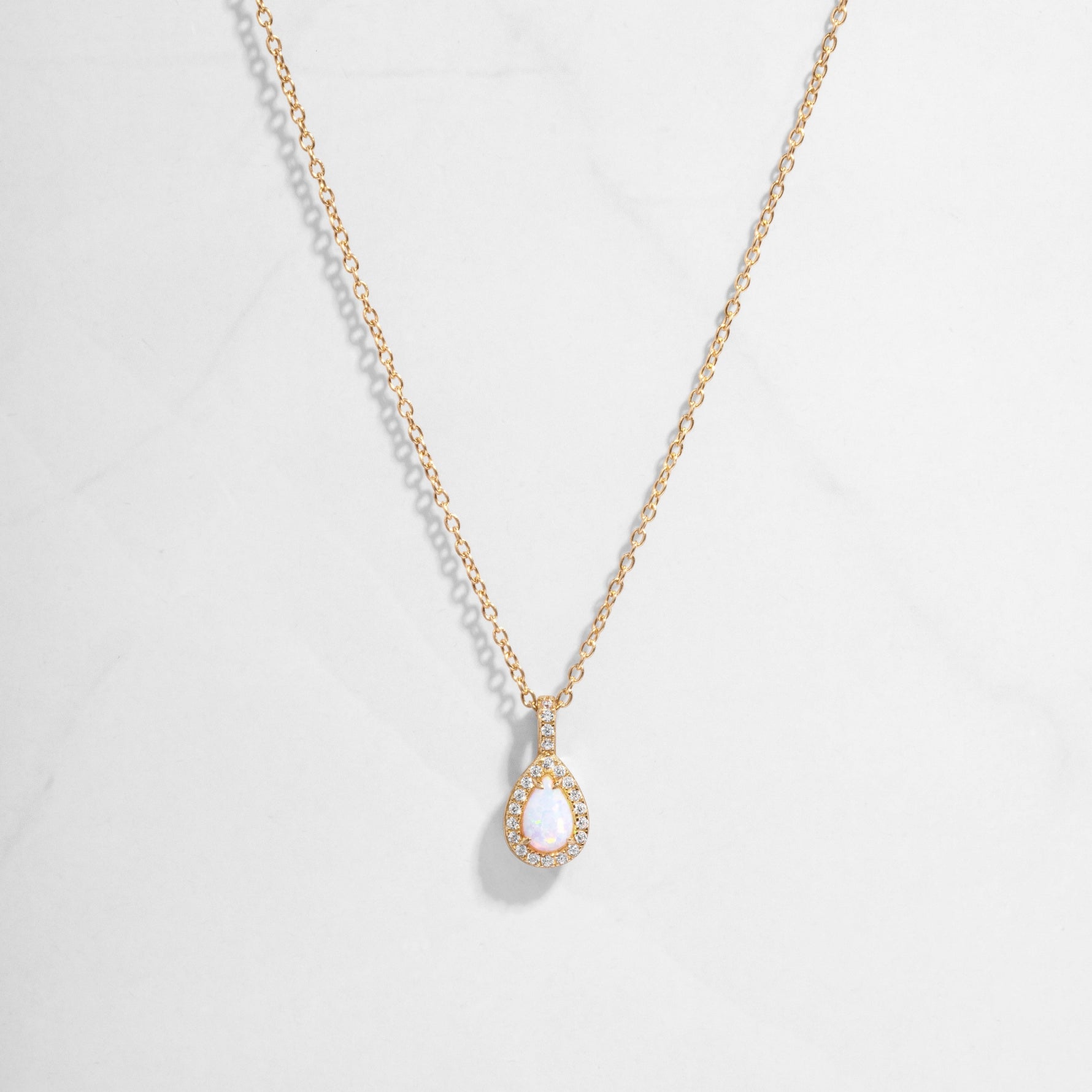 Closeup image of 14k gold plated necklace with opal gemstone