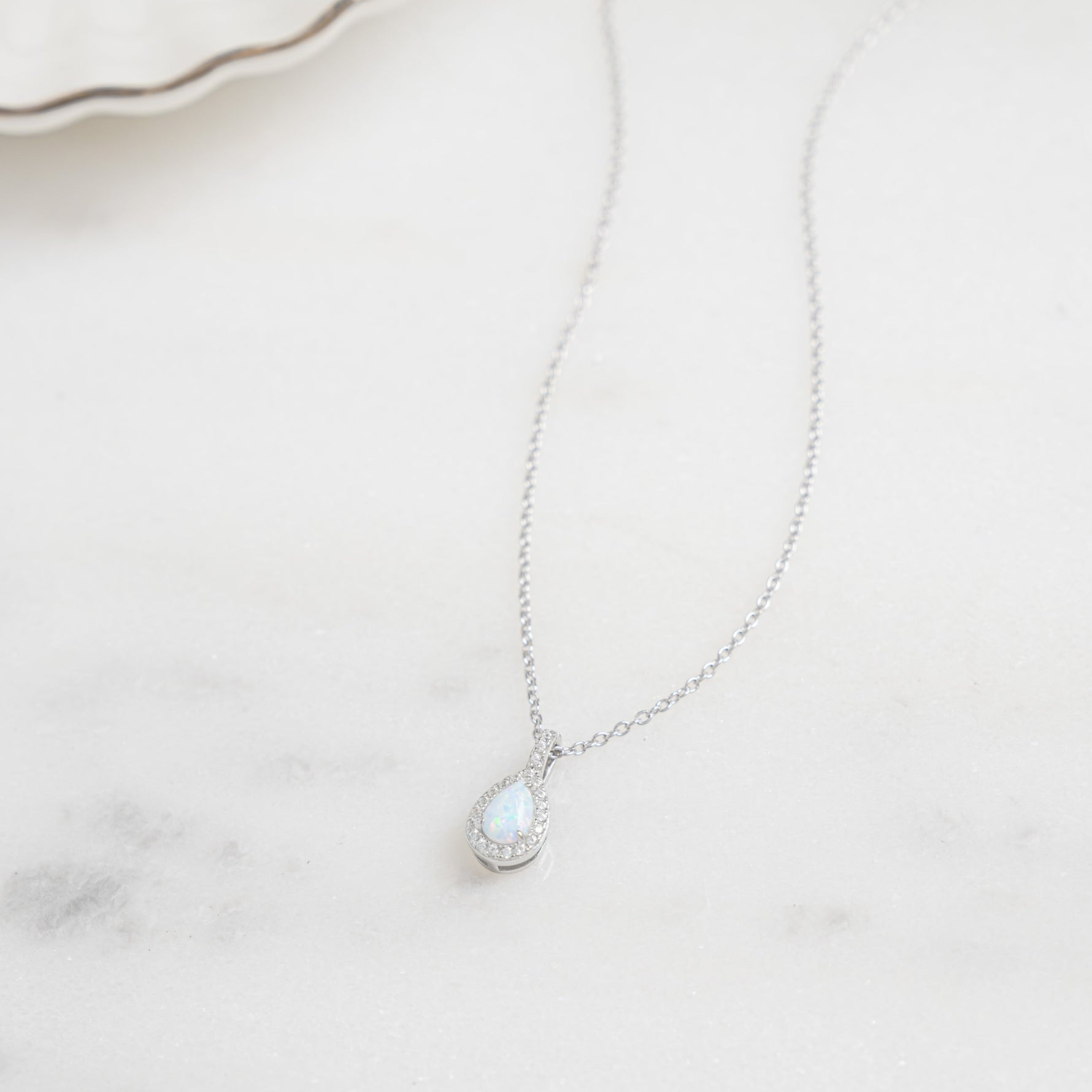 Closeup image of minimalist opal silver necklace 