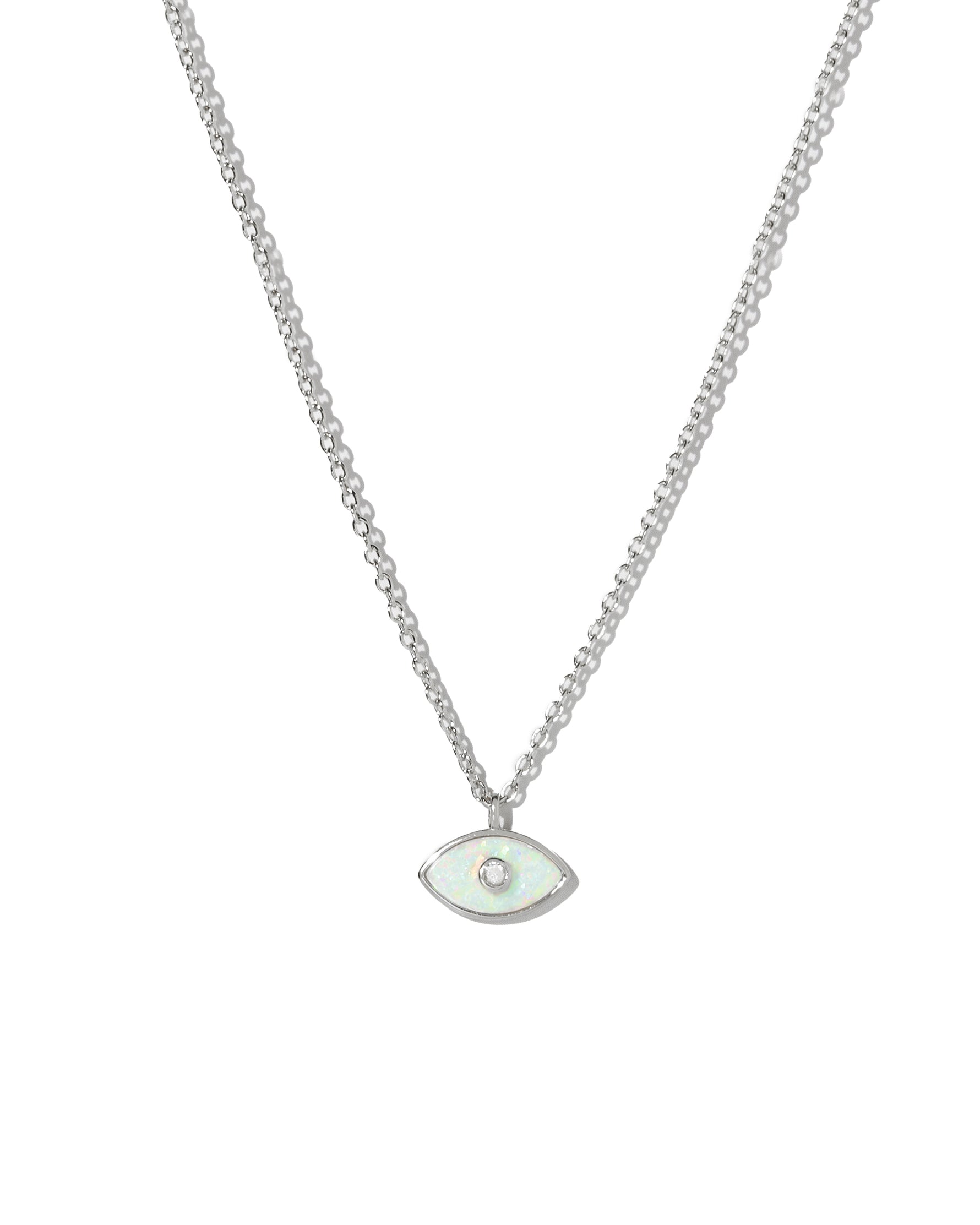 Silver necklace with a dainty opal evil eye pendant on a white background