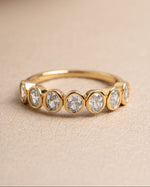 Gold bezel set vintage ring on a neutral background