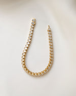 bridal jewelry featuring an oval diamond tennis bracelet with bezel set stones in 14k gold plating
