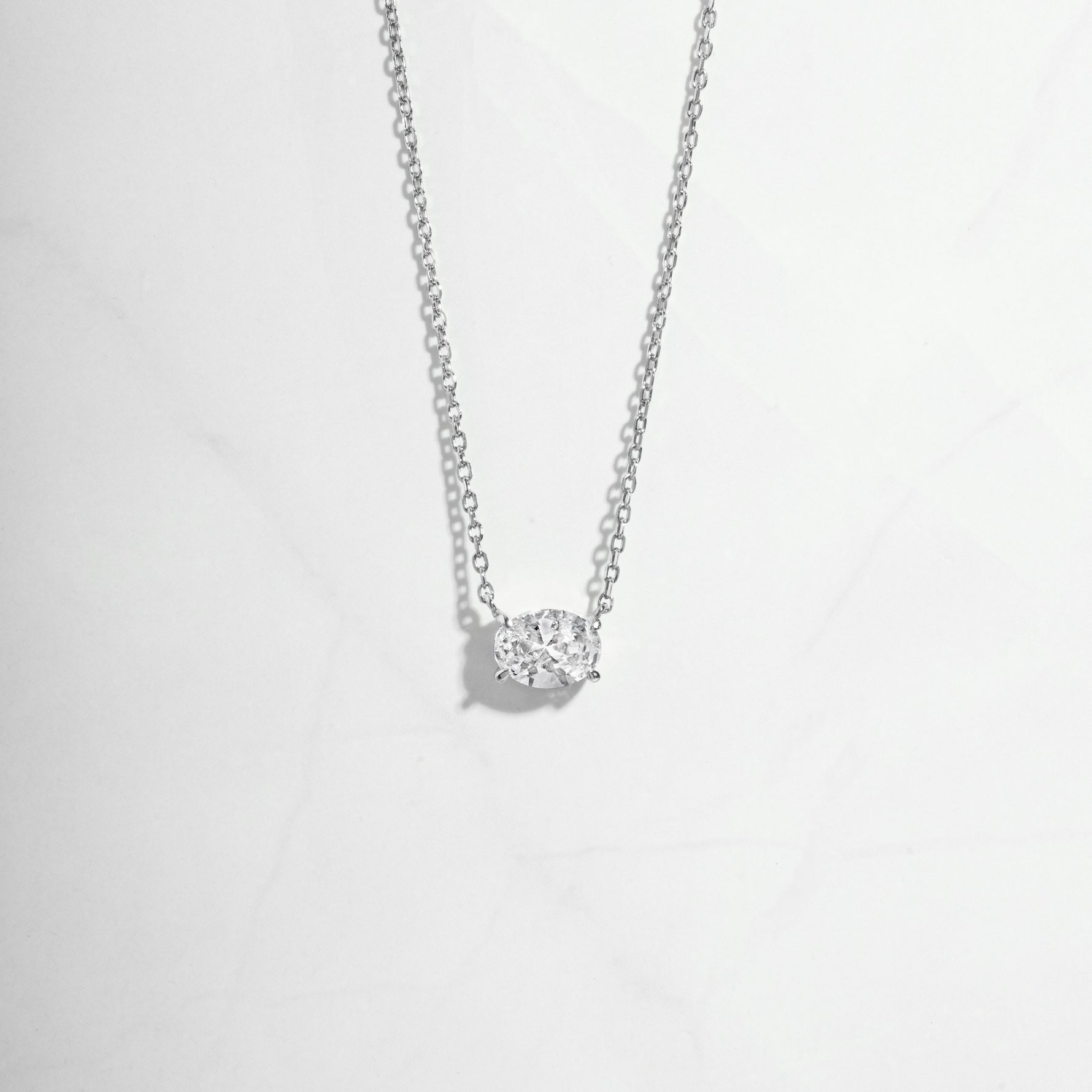 Closeup of silver necklace with diamond pendant 