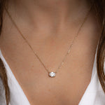 Model wearing dainty silver pendant necklace 