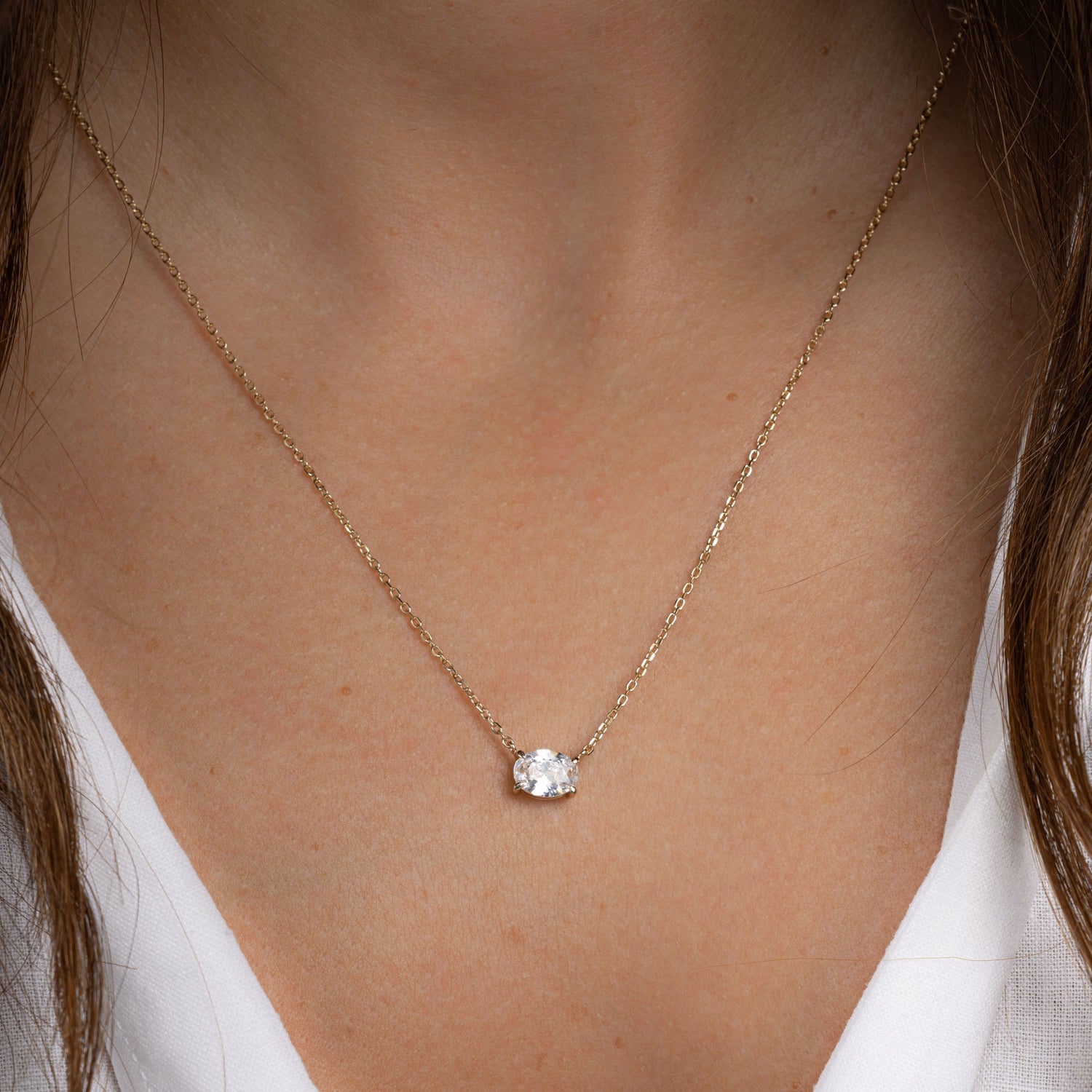 Model wearing dainty silver pendant necklace 