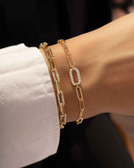 model wearing paperclip bracelets with cubic zirconia diamonds
