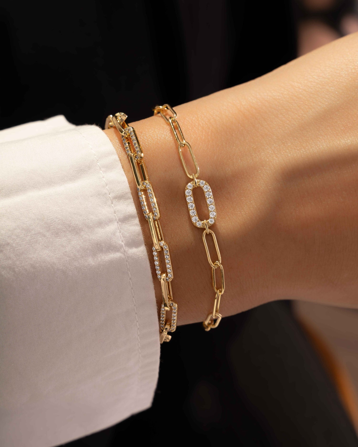 model wearing paperclip bracelets with cubic zirconia diamonds