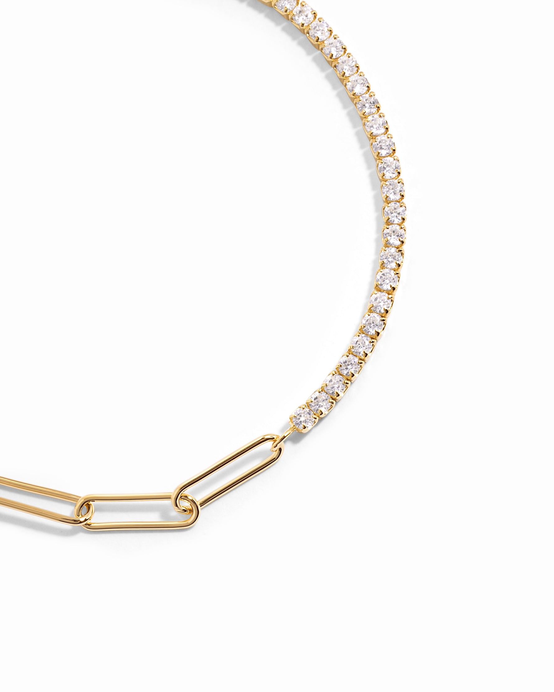 closeup image of gold bracelet with tennis chain and paperclip chain