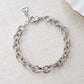 Closeup image of silver chain with chunky jewelry design