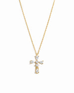 Gold cross necklace with pear cut diamonds on a white background