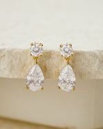 Gold bridal earrings featuring a pear drop earring design