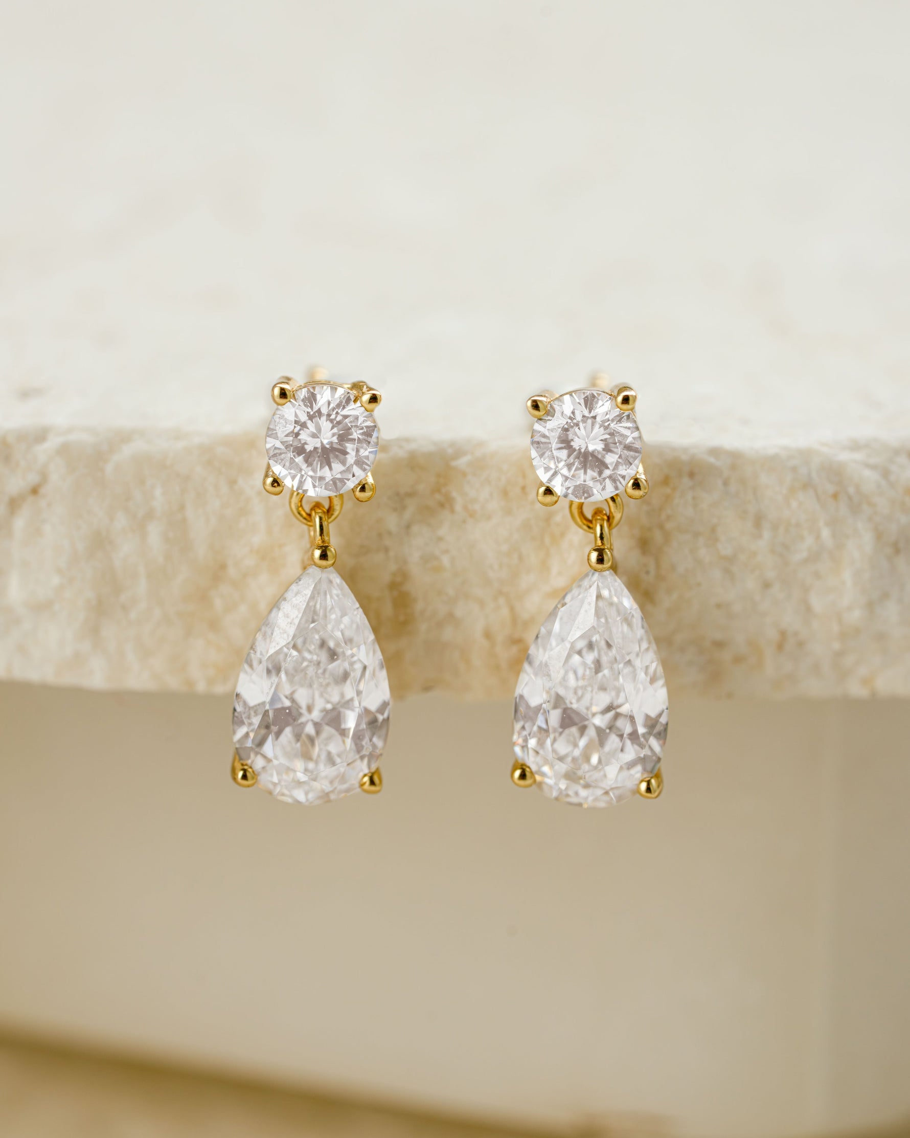 Gold bridal earrings featuring a pear drop earring design