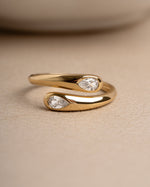 Gold dainty spiral ring on beige surface