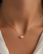 Gold diamond pendant layering necklace on model