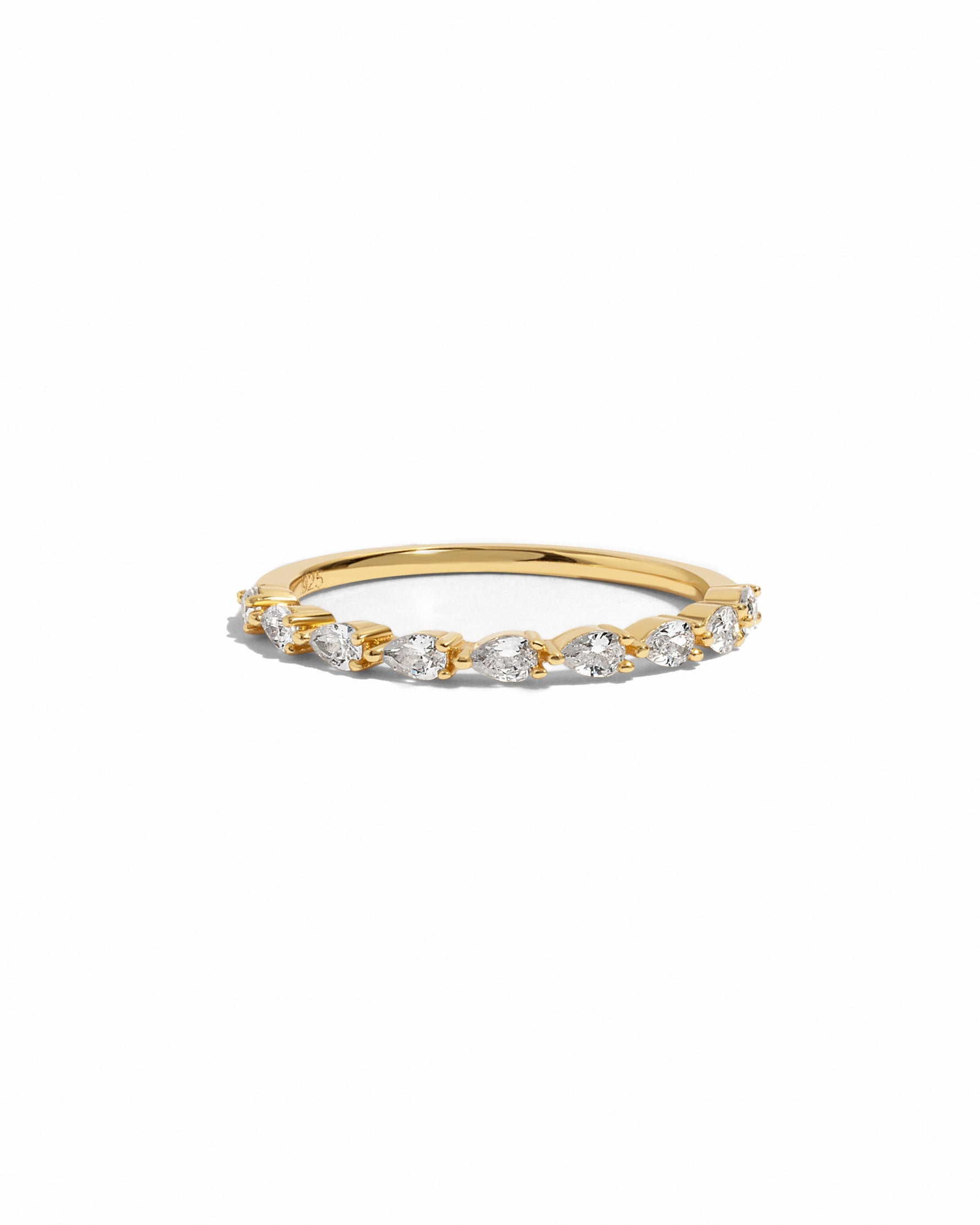 Gold ring with pear shaped diamonds on a white background