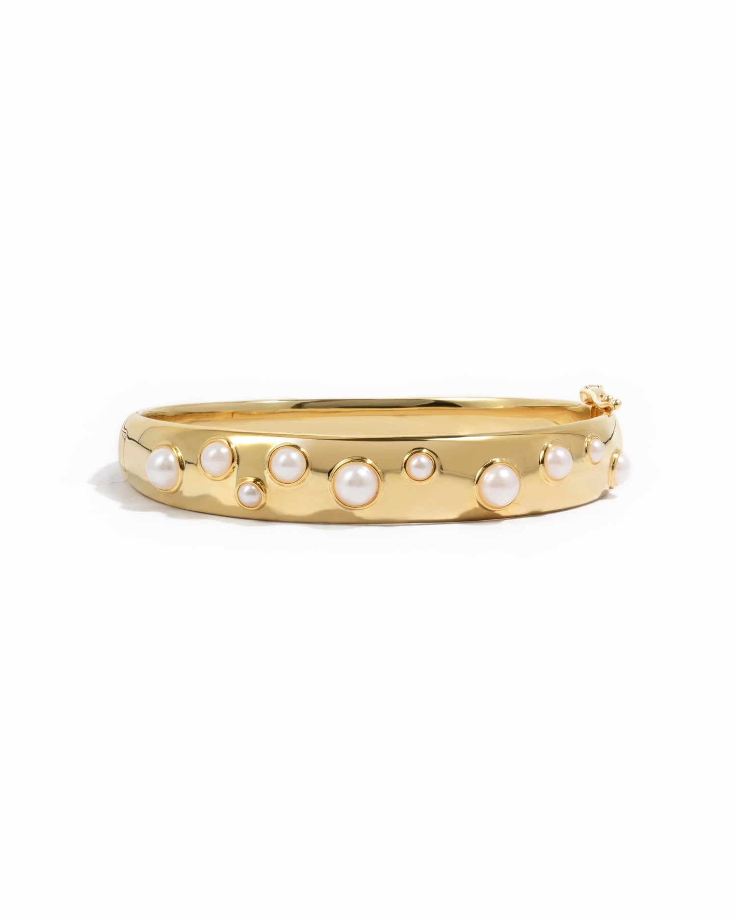 closeup image of pearl bangle in gold 