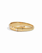 gold bangle bracelet with studded pearl design