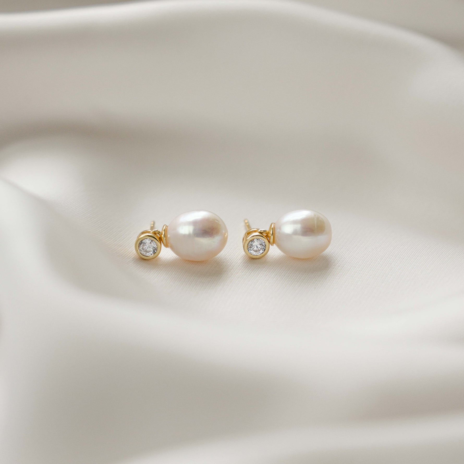side view of diamond pearl drop earrings in gold 