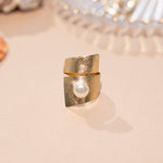 closeup image of pearl ring with spiral ring design