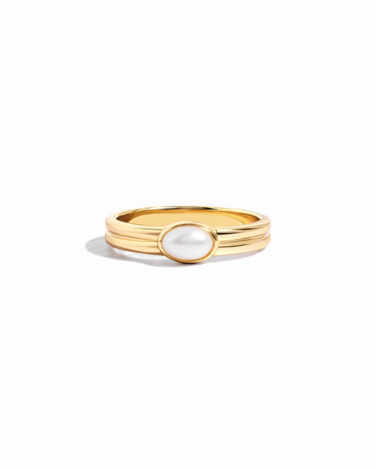 Closeup image of gold pearl stacking ring