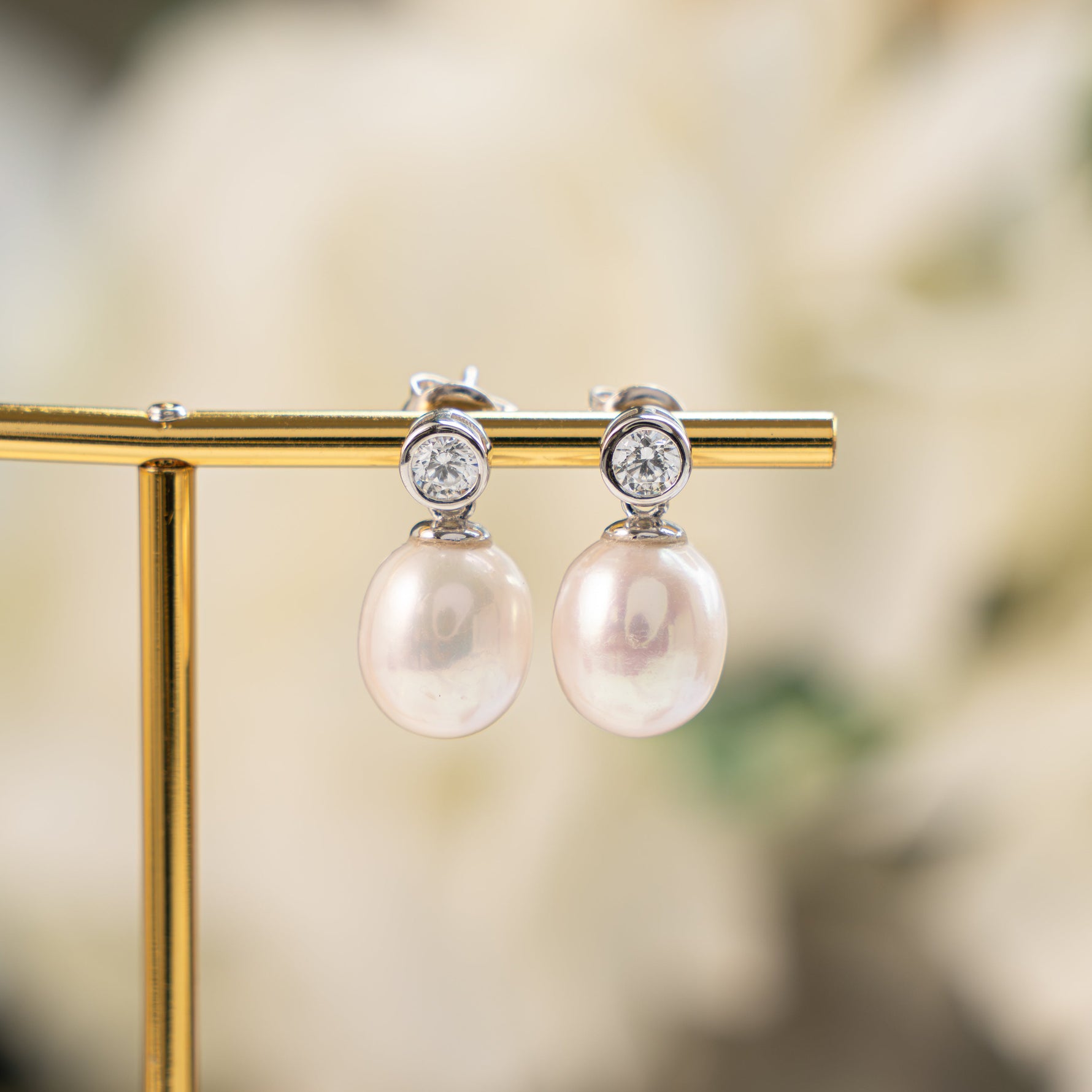 closeup image of sterling silver pearl drop earrings