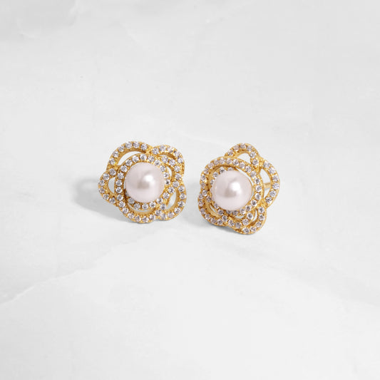 closeup image of statement earrings with pearl earring design and flower earring design in 14k gold plating 