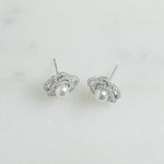 Closeup view of sterling silver stud earring with pearl flower earring design on silver stud 