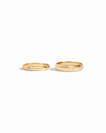 closeup image of 3mm plain gold band ring and 5mm plain eternity ring
