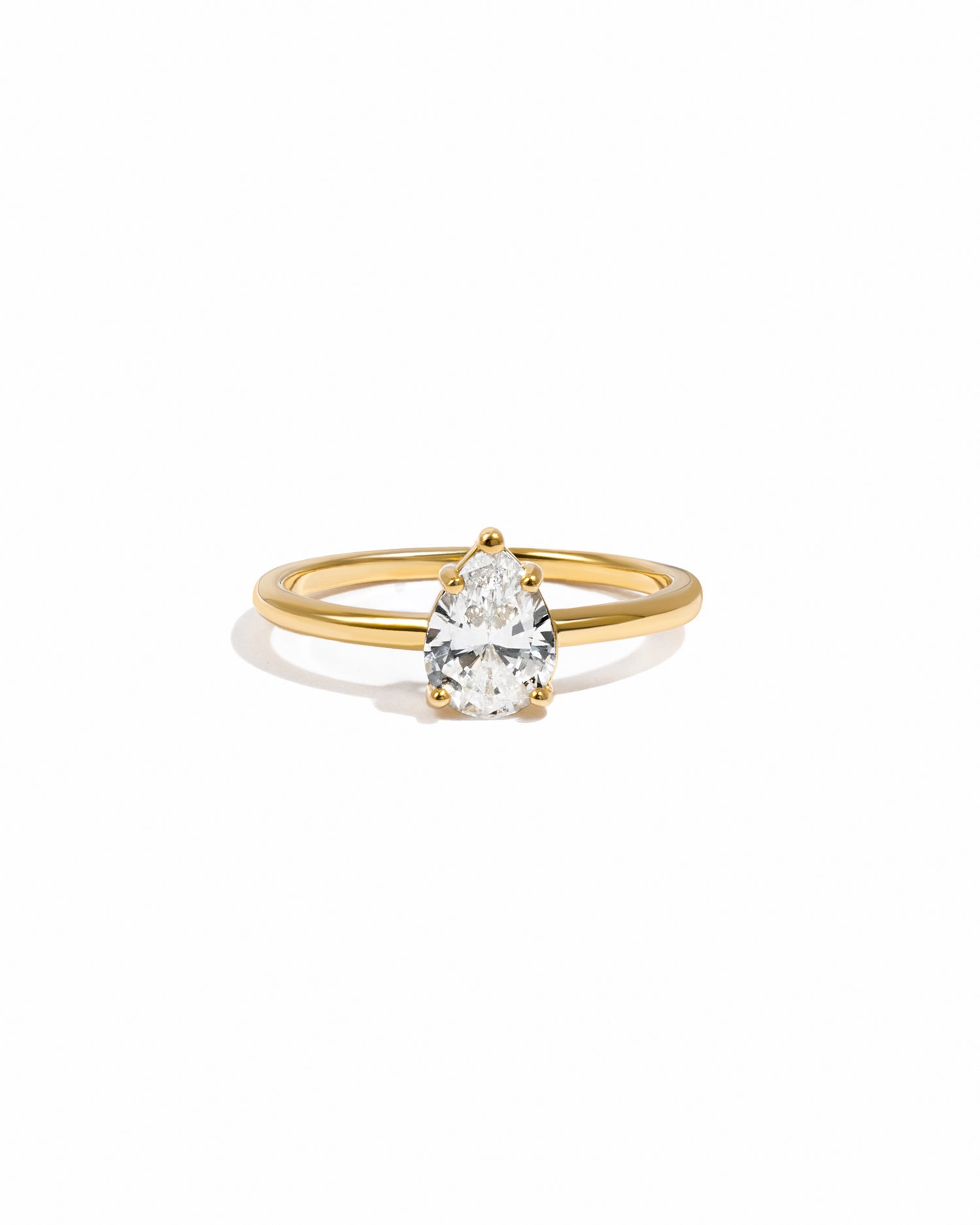 Pear solitaire diamond ring on a gold band 