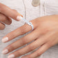 Close-up of a model wearing a ring sizer tool