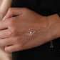 closeup image of model wearing rose gold  hand jewelry