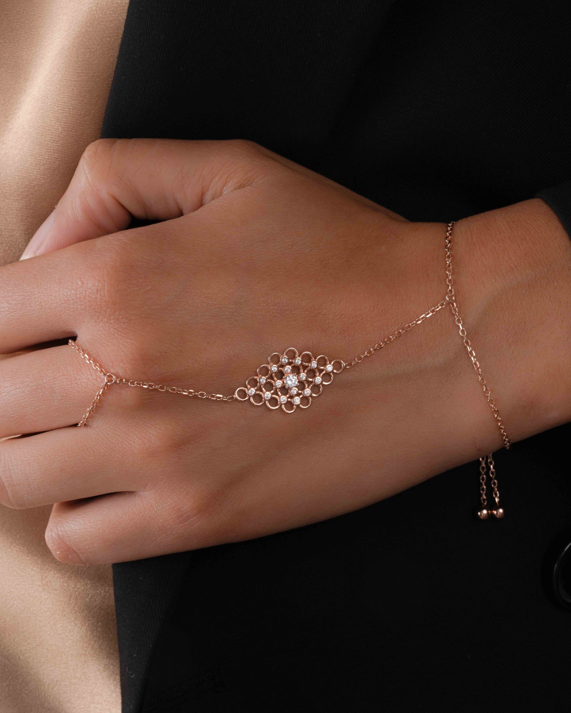 closeup image of model wearing rose gold  hand jewelry