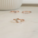 closeup image of rose gold ring featuring an opal celestial ring