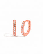 Rose gold diamond hoop earrings.