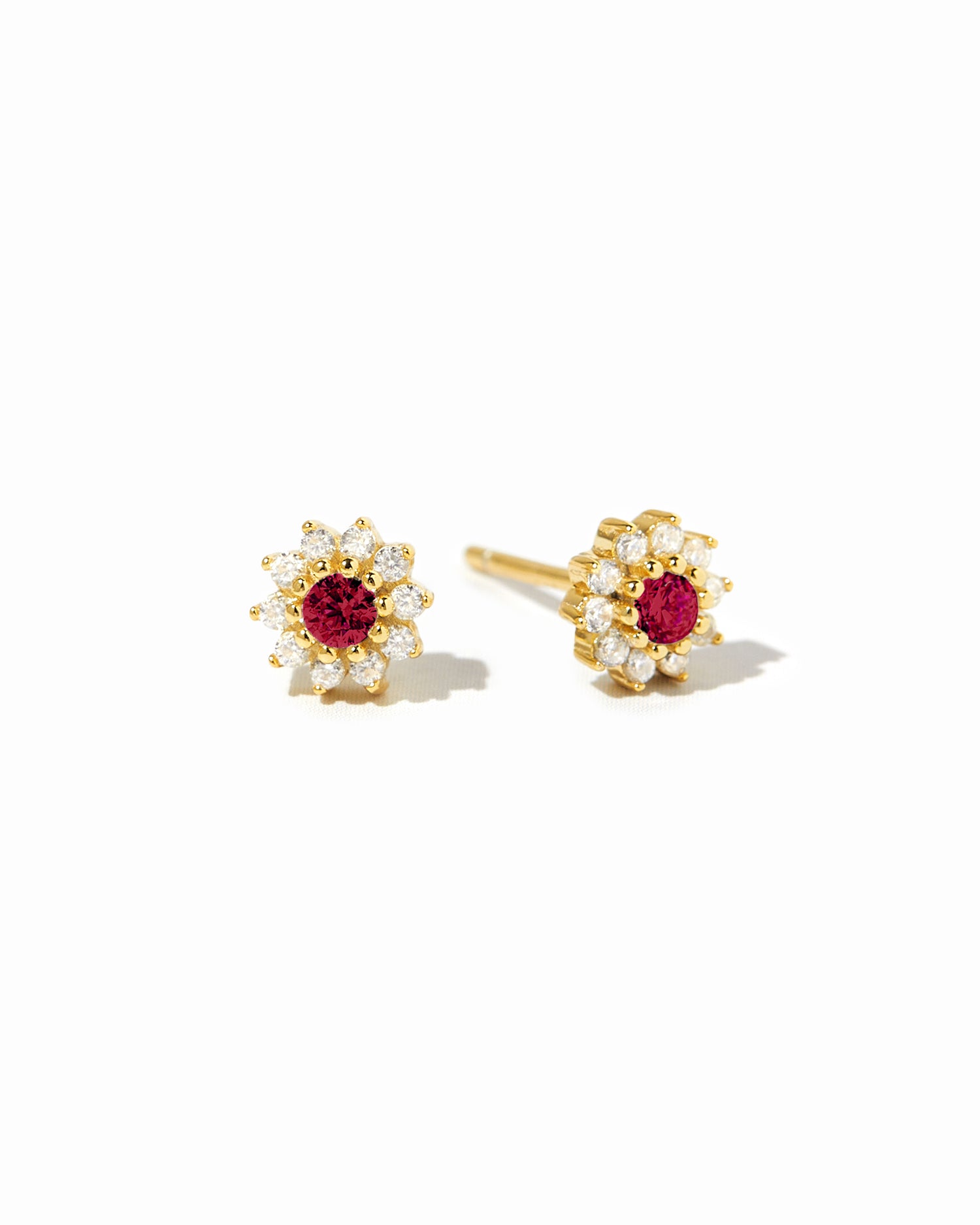 Gold dainty ruby flower stud earrings.