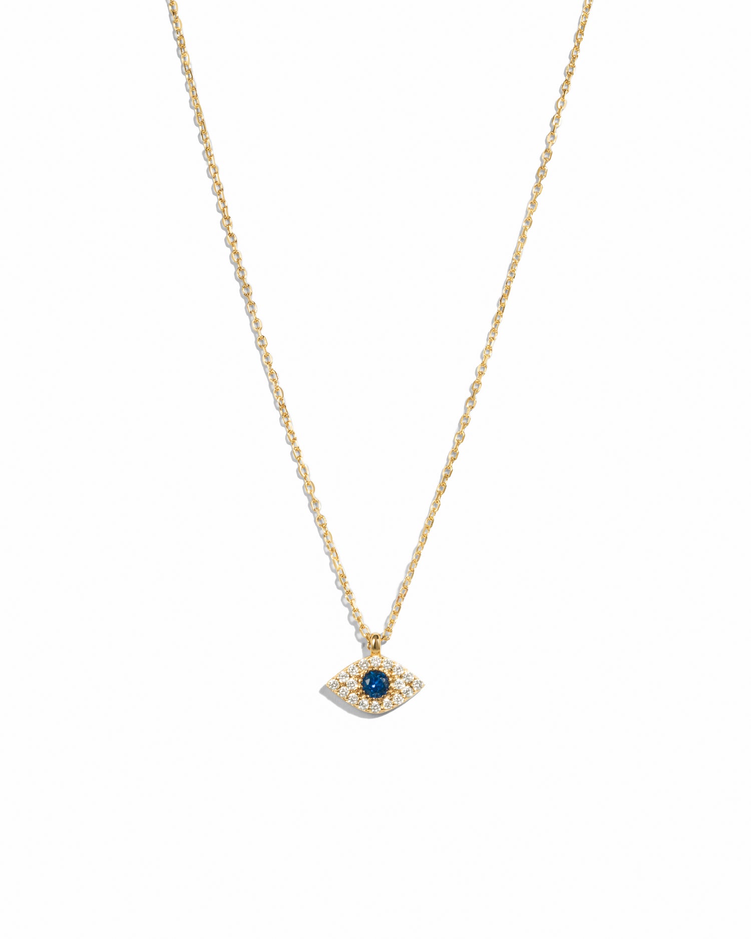 Gold necklace with a sapphire blue gemstone evil eye pendant on a white background