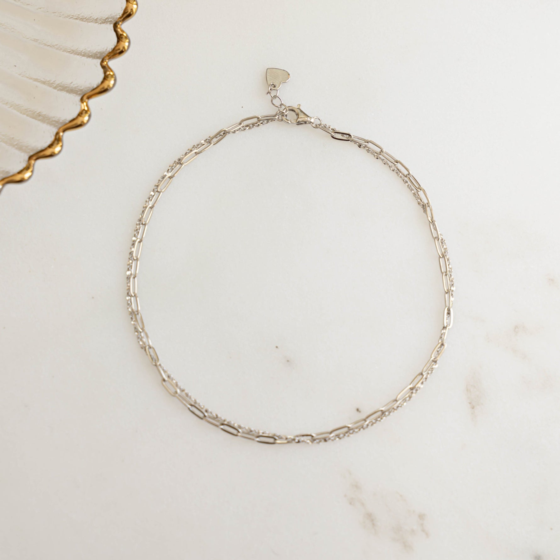 closeup of sterling silver ankle bracelets