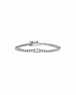 Silver tennis bracelet with small baguette on a white background