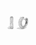 Pair of silver huggies with baguette-cut cubic zirconia stones on a white background